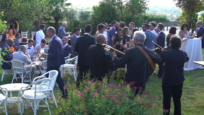 The Italian wedding folk trio playing during an aperitif in a villa in Tuscany